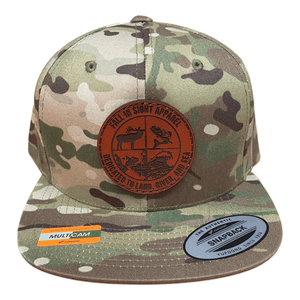 Camo colored fis flatbill hat with a round leather patch of a scope design with an elk and a salmon