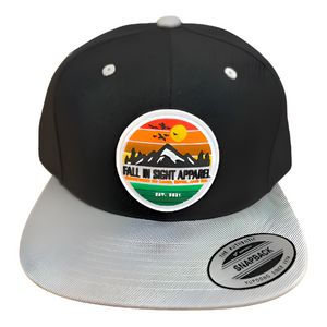 Black fis trucker hat with a Gray bill with a retro mountain patch on the front