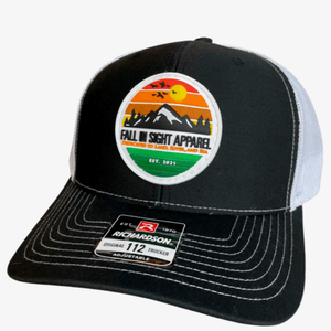 Black and white fis trucker hat with a retro mountain patch on the front